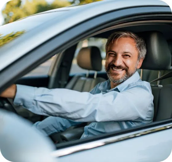 man happily driving car